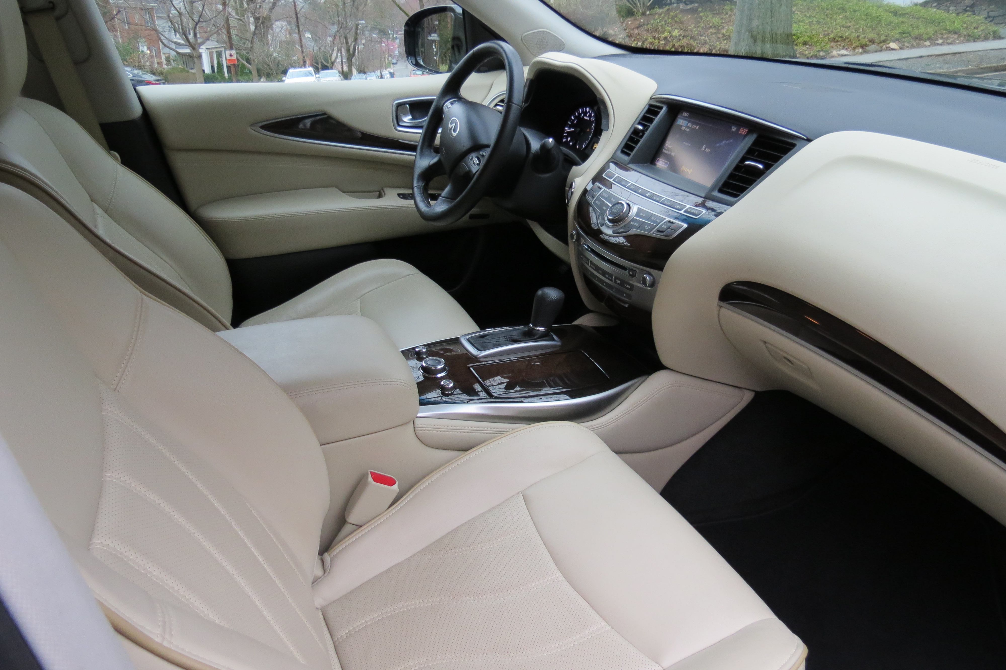 The inside of the Infiniti QX60 features wheat colored leather and maple wood trim accents.