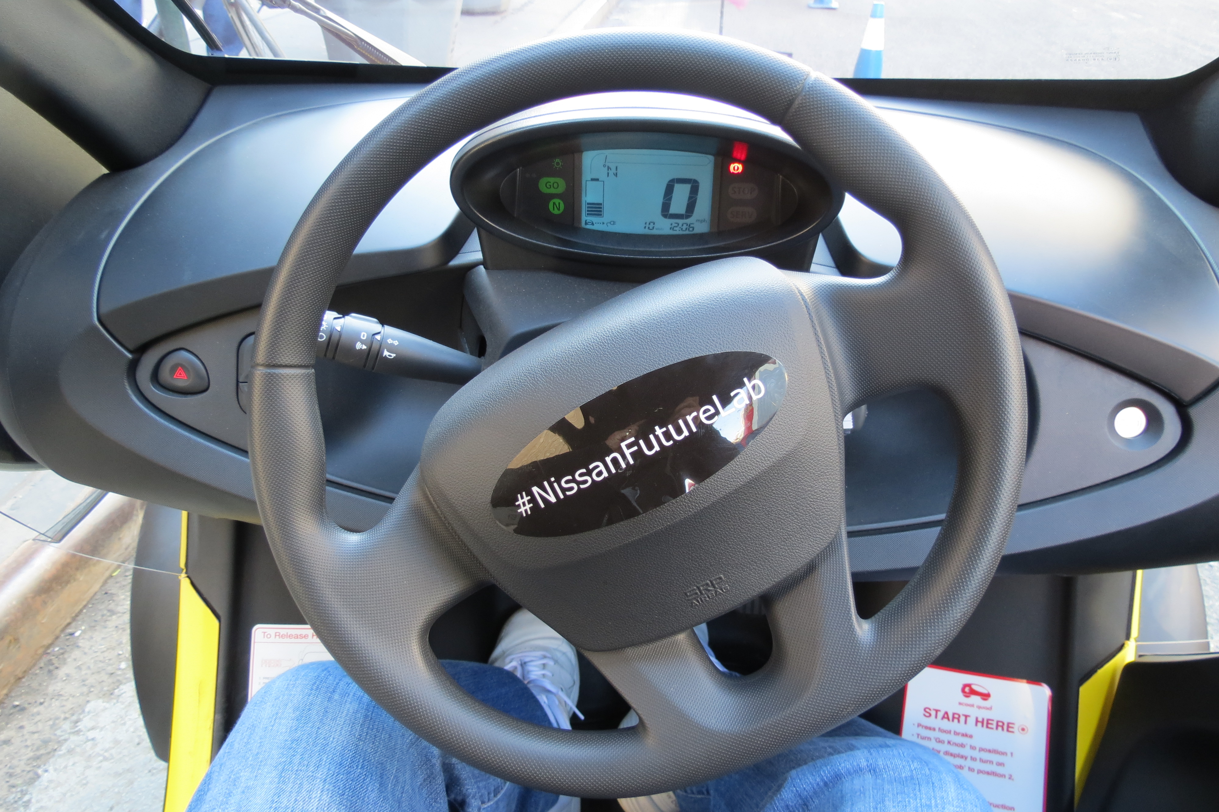 Looking inside the cockpit of the Nissan Mobility Concept Vehicle. A very simple dashboard with basic controls.