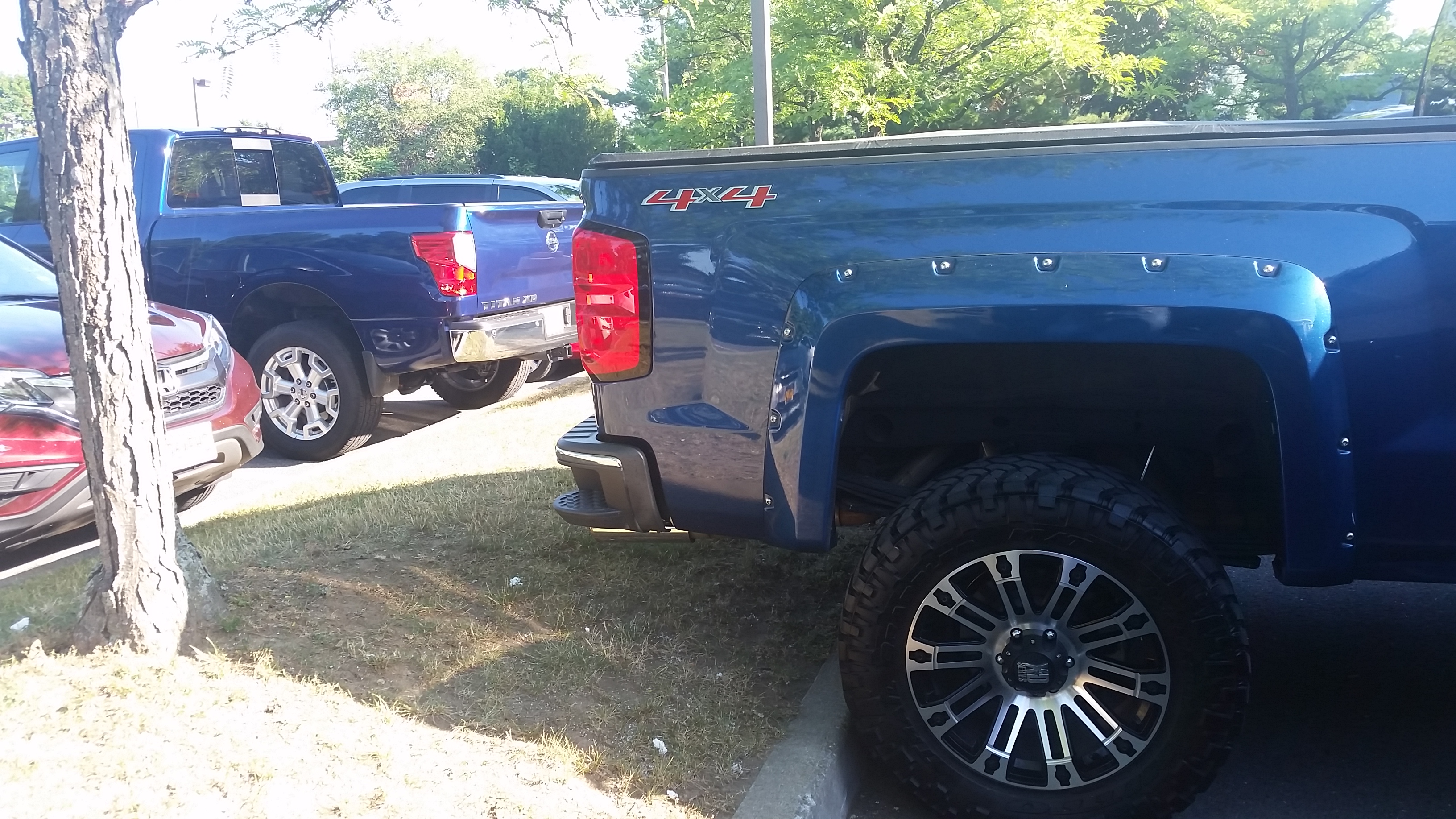 The Chevrolet Silverado 4x4 (front) and the Nissan Titan XD (Rear,) are both full size 4X4 Pickup trucks and take up plenty of space.
