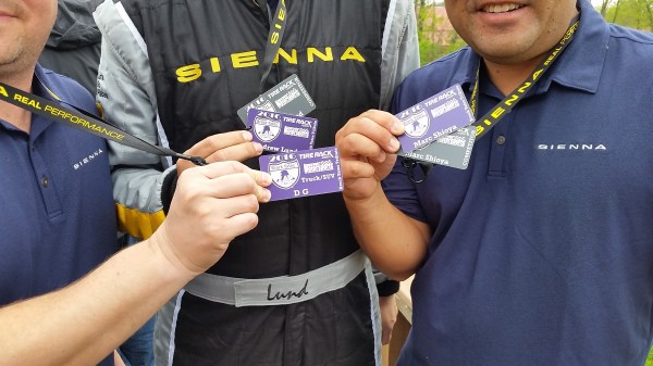 The Toyota Sienna 2016 One Lap America Team, showing off their badges, showing they have donated to the charity.