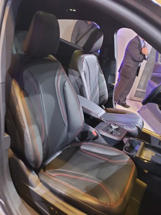 Ford MachE interior with stitched seats, cupholders and places for two mobile phones to charge.