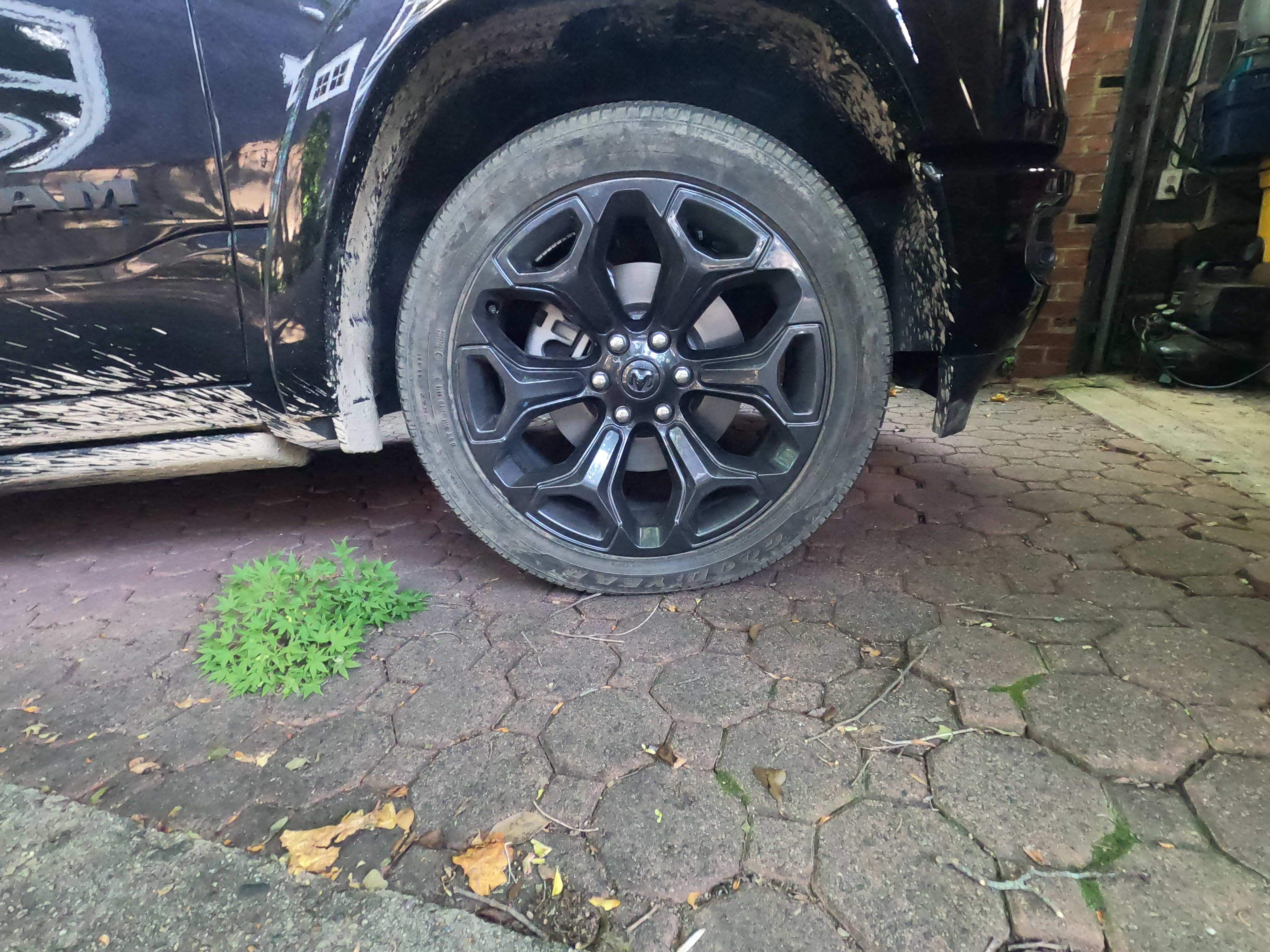 Ram 1500 22 by 9 inch black rims with Goodyear tires