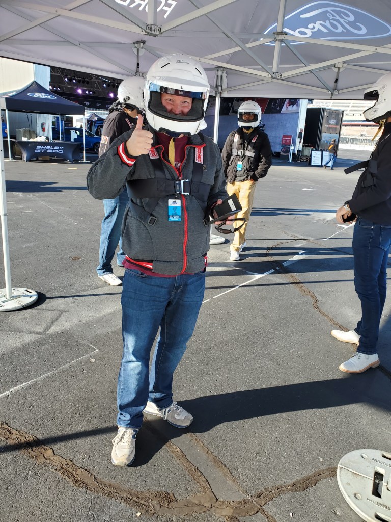 Officer Matt Rihl helmeted and harnessed up prior to driving a SHELBY GT 500 on the Charlotte Motor Speedway Track at speed. October 19 2020