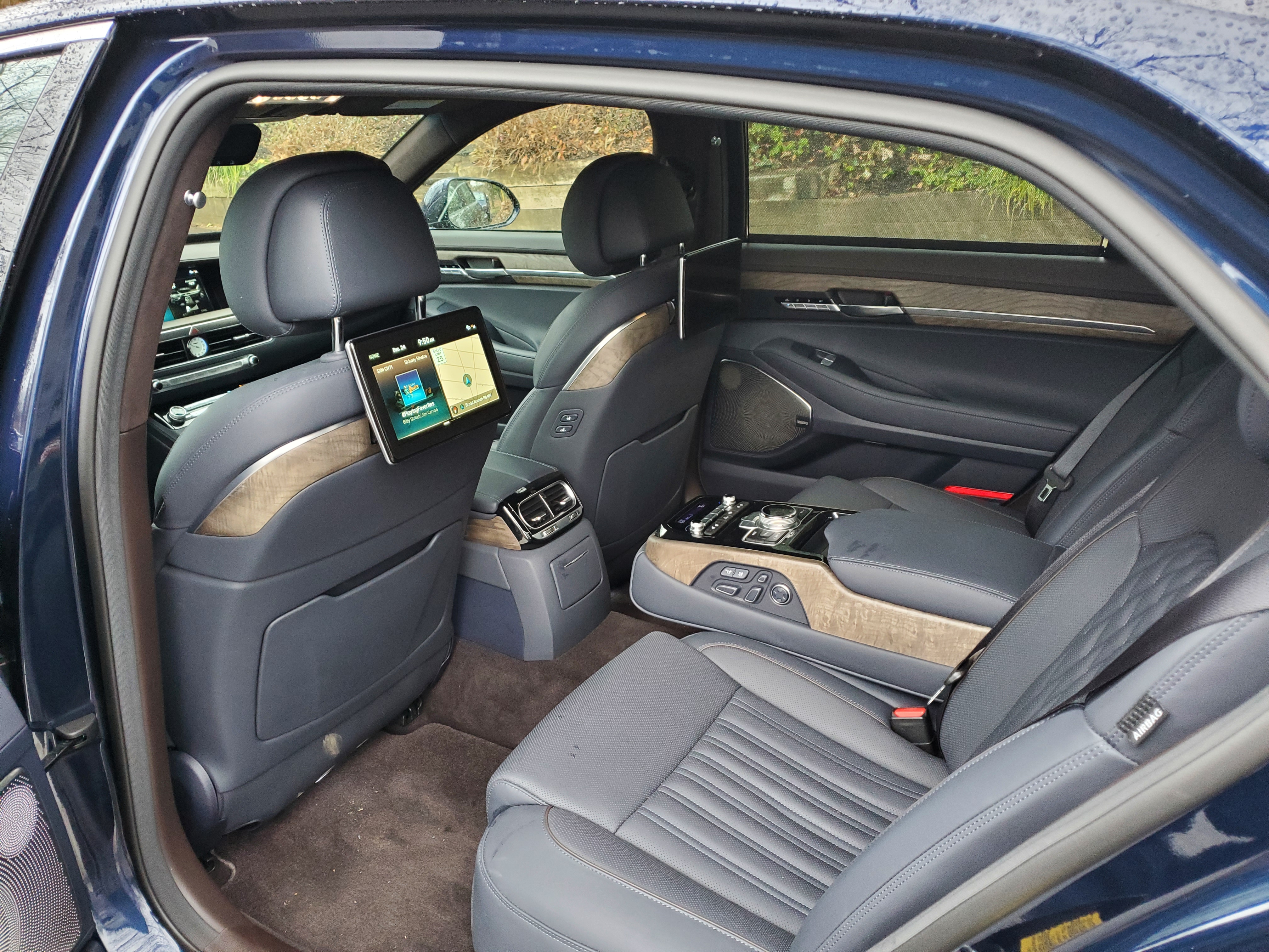 The two rear outboard monitors on the G90 have controls located in the fold-down center armrest.