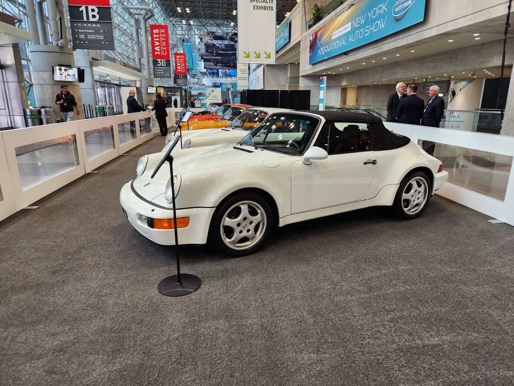 A classic white widebody Porsche 911 cabrio on display at the 2024 NYIAS.